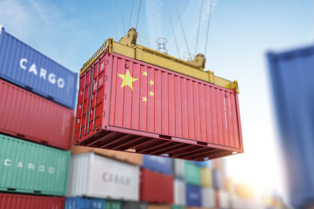 Cargo shipping container with China flag in a port harbor. Production, delivery, shipping and freight transportation of chinese products concept.