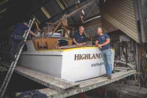 Michael and Stephen copy Founder Michael Dennett (left, in the cockpit) and his son Stephen. Refits and renovations are their stock and trade. PHOTO COURTESY MICHAEL DENNETT BOAT BUILDERS