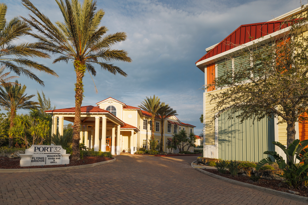 View of a building with palm trees around it.