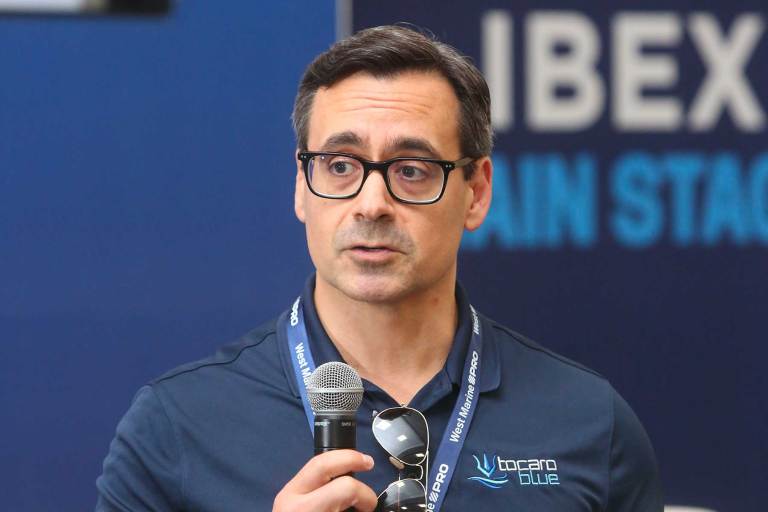 Man with a microphone at an event.